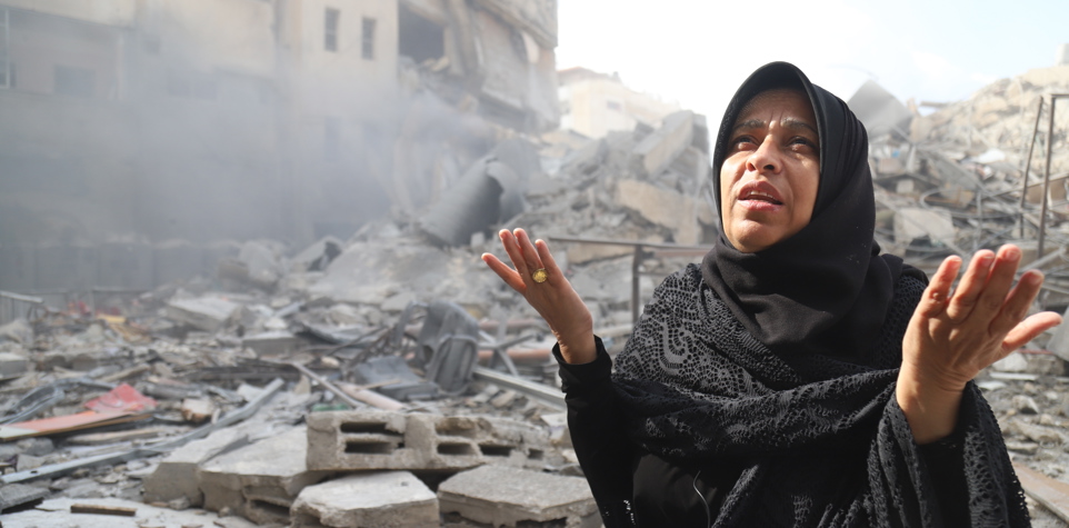 A woman in Gaza kneeling down in prayer