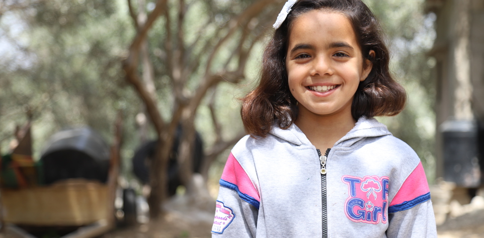 Photo of a young Palestinian girl with an infectious smile
